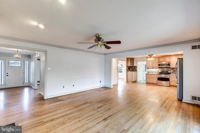 unfurnished living room with crown molding, ceiling fan, and light wood-type flooring