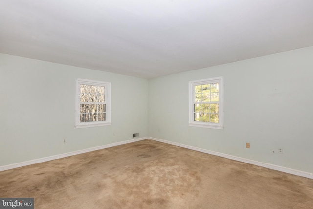 unfurnished room with light colored carpet