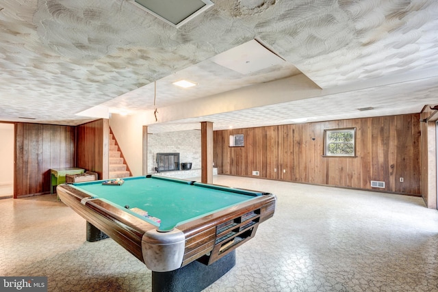 recreation room with wood walls and pool table