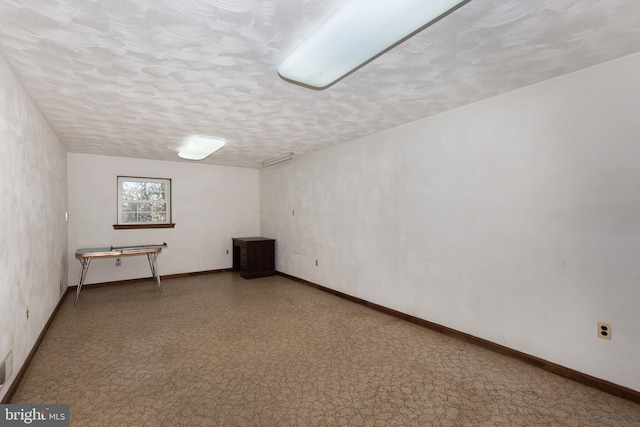 basement featuring a textured ceiling