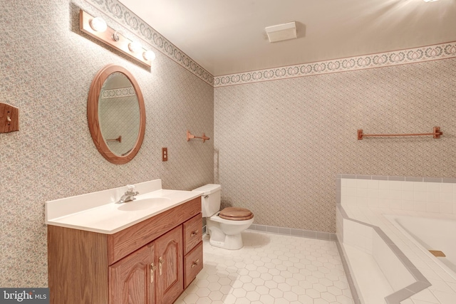 bathroom with tile patterned floors, vanity, toilet, and a bathing tub