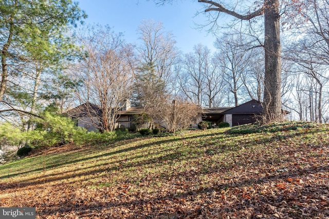 exterior space with a garage and a front lawn