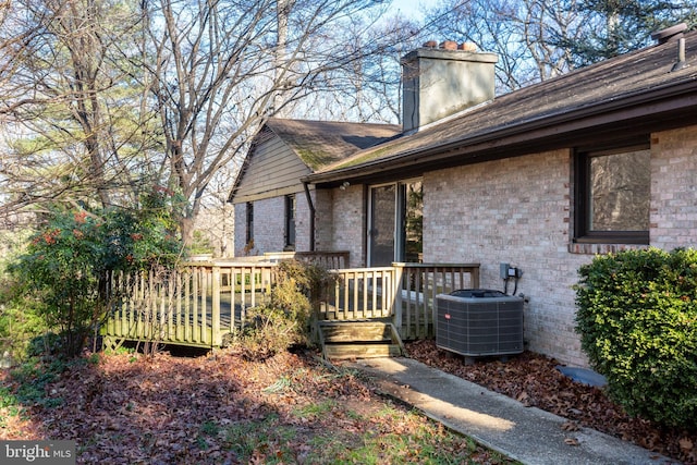 exterior space featuring cooling unit and a deck