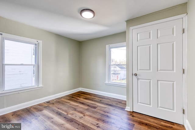 spare room with hardwood / wood-style flooring