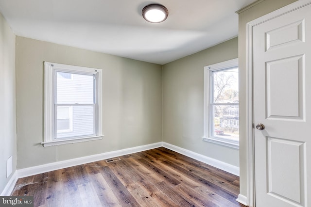 spare room with dark hardwood / wood-style floors