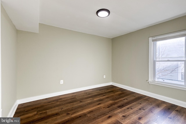 spare room with dark hardwood / wood-style flooring