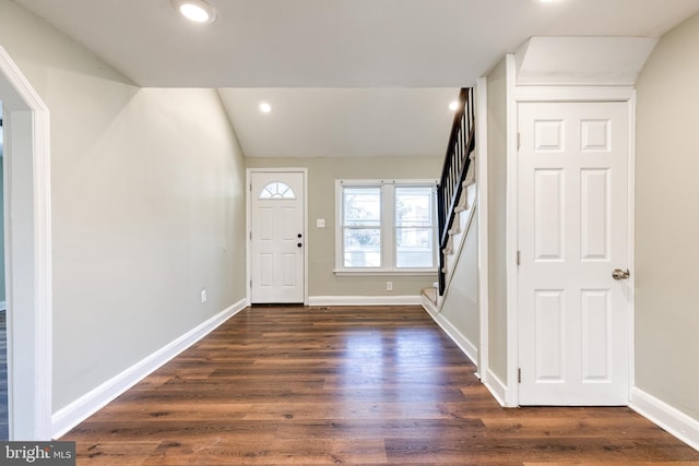 foyer with dark hardwood / wood-style floors and vaulted ceiling