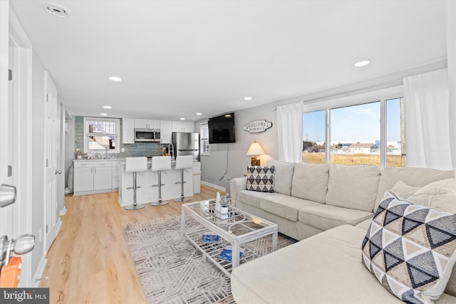 living room with light hardwood / wood-style flooring