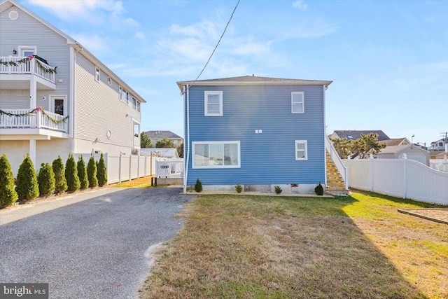 rear view of house with a yard