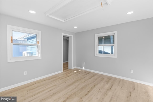 spare room with light hardwood / wood-style flooring