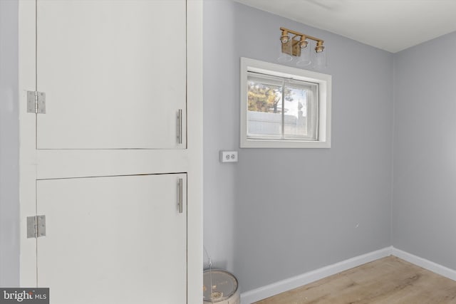 laundry room featuring light hardwood / wood-style floors