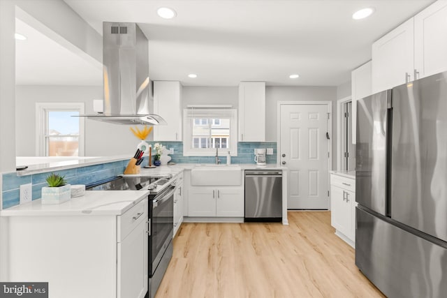 kitchen featuring white cabinetry, sink, a healthy amount of sunlight, stainless steel appliances, and range hood