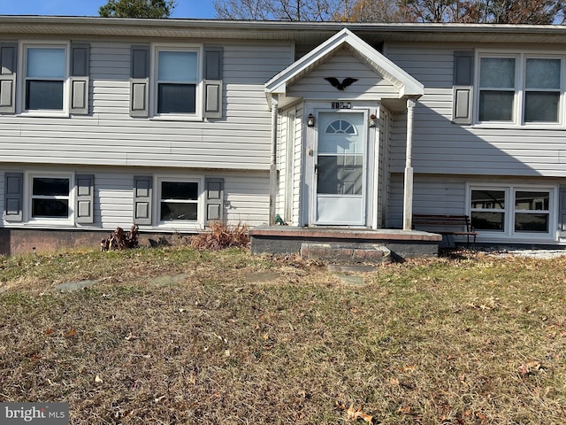 entrance to property featuring a lawn