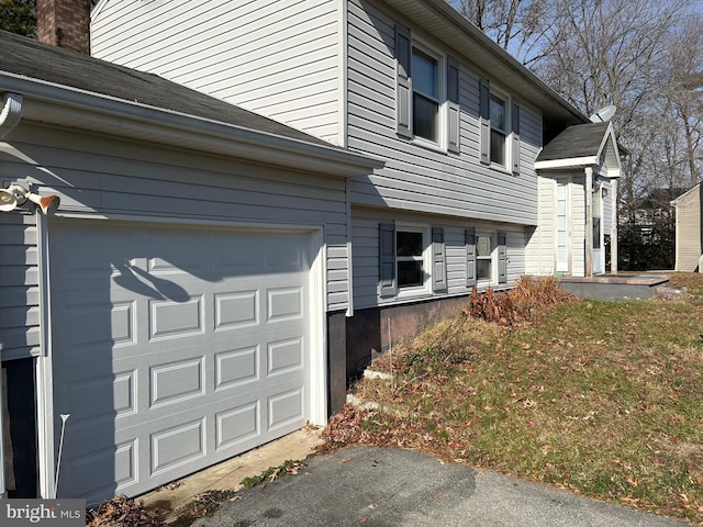 view of side of property with a garage