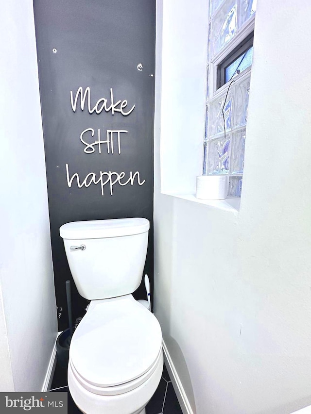 bathroom featuring tile patterned flooring and toilet