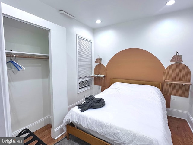 bedroom featuring dark hardwood / wood-style flooring and a closet