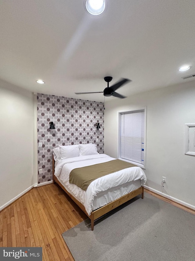 bedroom with ceiling fan and light wood-type flooring