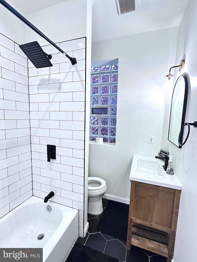 full bathroom with tile patterned flooring, vanity, toilet, and tiled shower / bath