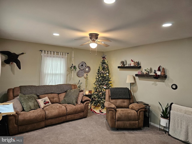 living room with ceiling fan and carpet