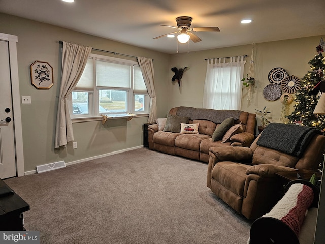 living room featuring carpet flooring and ceiling fan