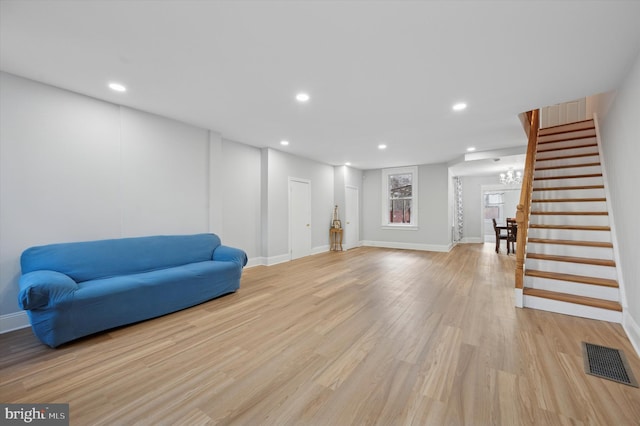 sitting room featuring light hardwood / wood-style floors and an inviting chandelier