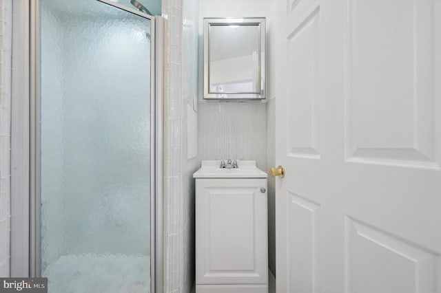 bathroom featuring vanity and an enclosed shower