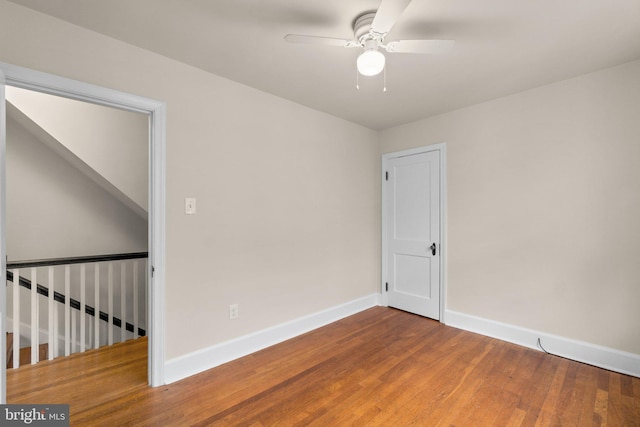 empty room with ceiling fan and wood-type flooring