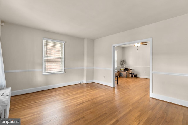 empty room featuring light wood-type flooring and ceiling fan