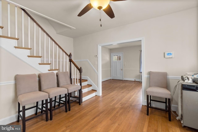 foyer with ceiling fan and light hardwood / wood-style floors