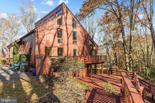 rear view of house featuring a deck