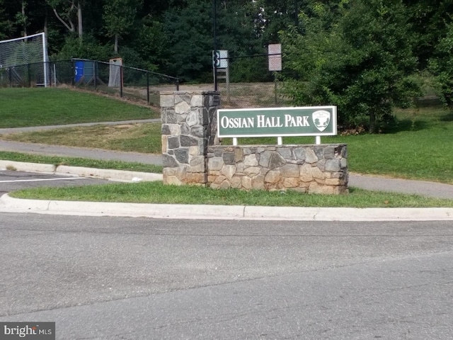 community sign featuring a lawn