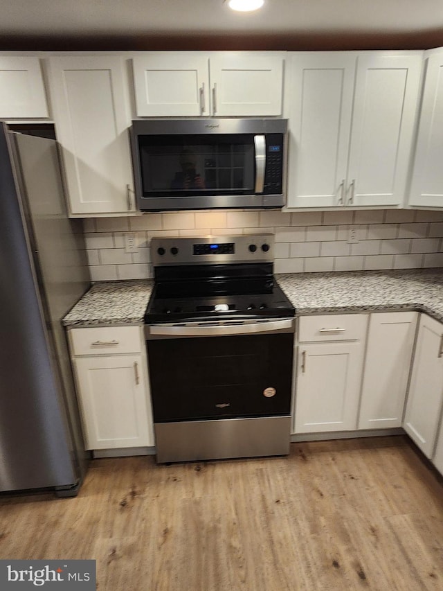 kitchen featuring white cabinetry and appliances with stainless steel finishes