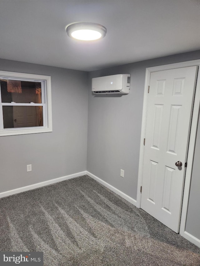 empty room with carpet floors and a wall mounted air conditioner