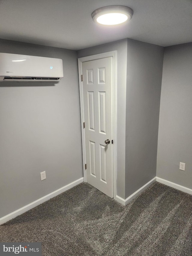 interior space featuring an AC wall unit and dark carpet