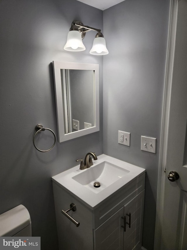 bathroom featuring vanity and toilet