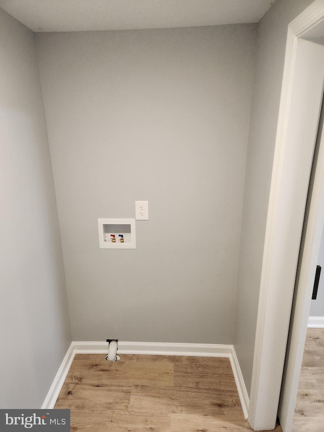 laundry room featuring hookup for a washing machine and light hardwood / wood-style flooring