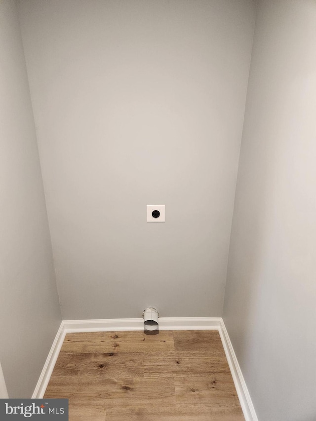 washroom featuring electric dryer hookup and wood-type flooring