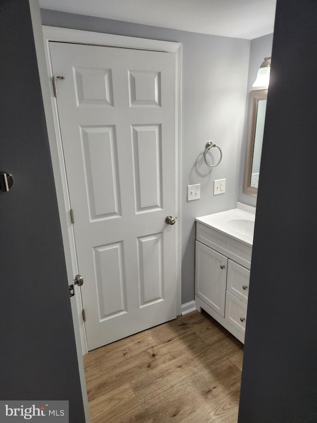 bathroom with hardwood / wood-style floors and vanity