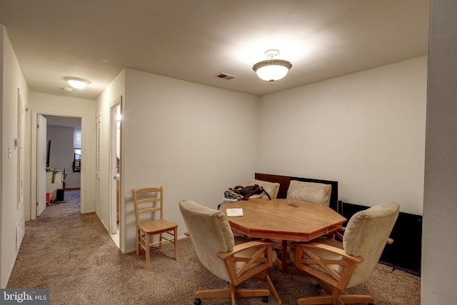 dining space with light colored carpet