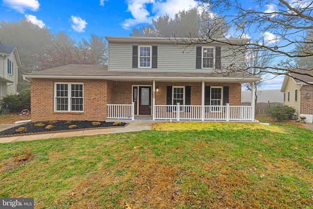 front of property featuring a porch and a front yard