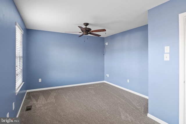 empty room with carpet flooring, ceiling fan, and plenty of natural light