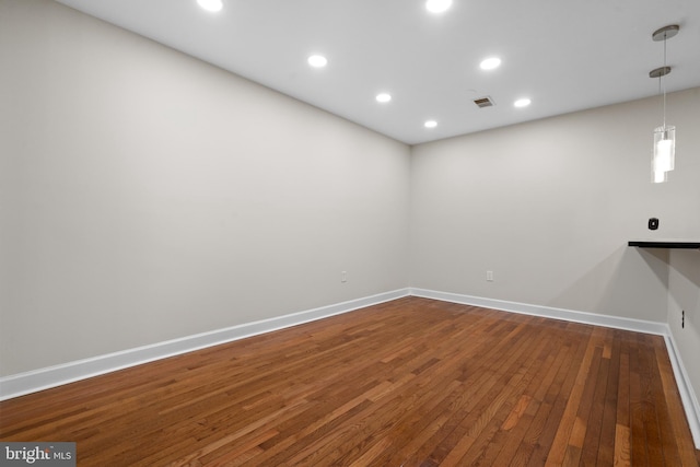 unfurnished room with hardwood / wood-style floors