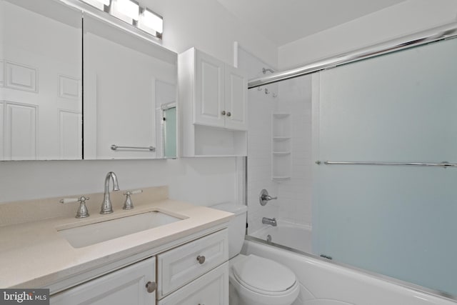 full bathroom with vanity, toilet, and bath / shower combo with glass door