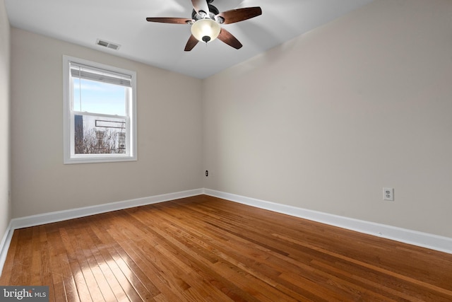 empty room featuring ceiling fan and hardwood / wood-style floors