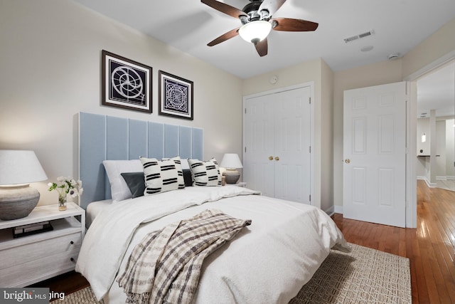 bedroom with ceiling fan, a closet, and hardwood / wood-style floors