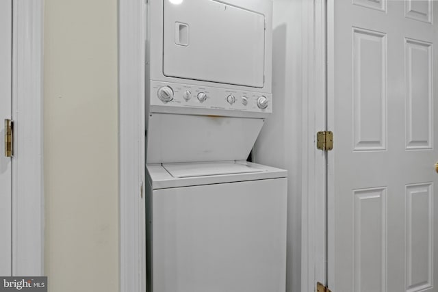 clothes washing area featuring stacked washer / drying machine