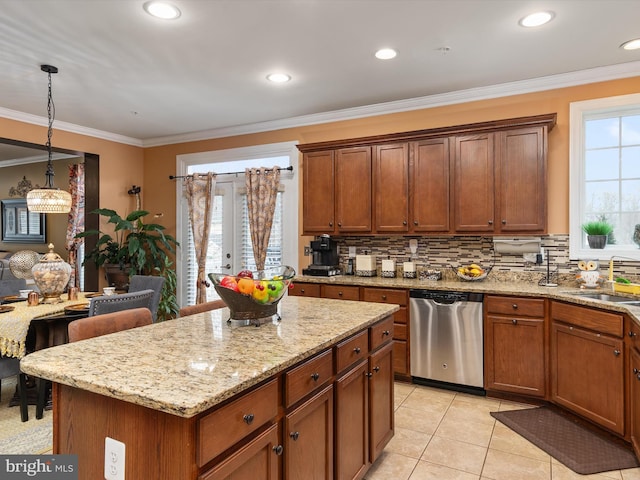 kitchen featuring crown molding, pendant lighting, dishwasher, and a kitchen island