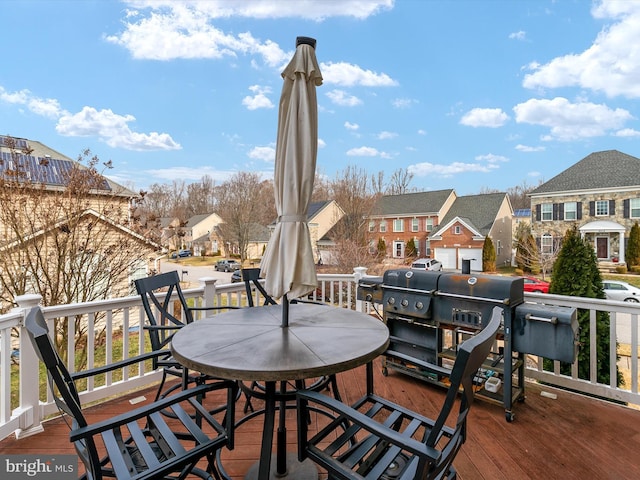 wooden deck featuring a grill