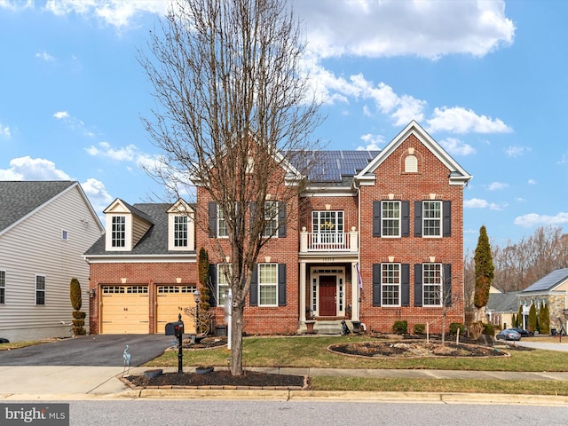 view of front of house with solar panels and a garage