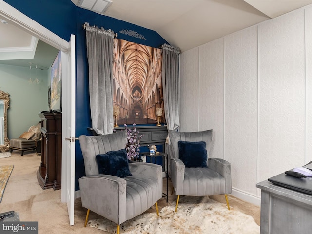 sitting room with lofted ceiling and carpet floors